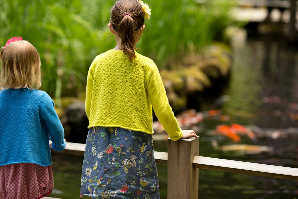 Sisters view the Koi on Children's Day. Photo by Scott Ryan