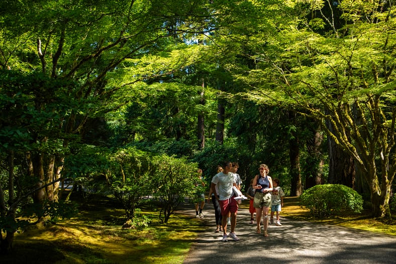 Visitors to Portland Japanese Garden walk down one of its paths in summer.